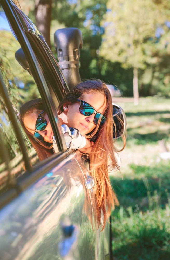 Young woman looking back through the window car