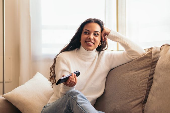 At-home entertainment: young woman enjoying television