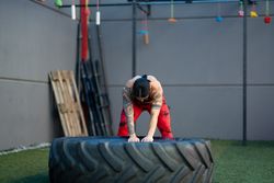 Woman working out with large tire