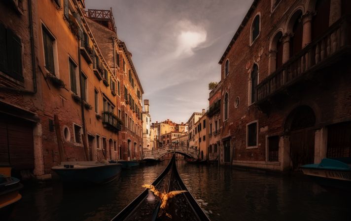 Golden bird gondola floating between colored houses