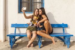 Girlfriends sitting on bench