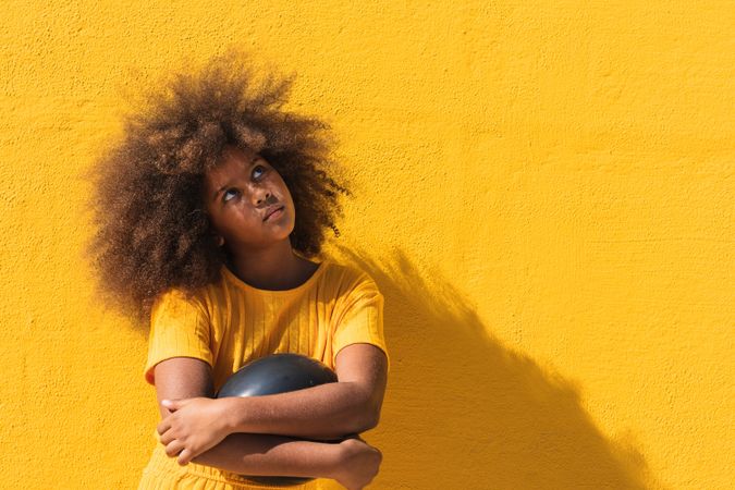 Black girl holding party balloon