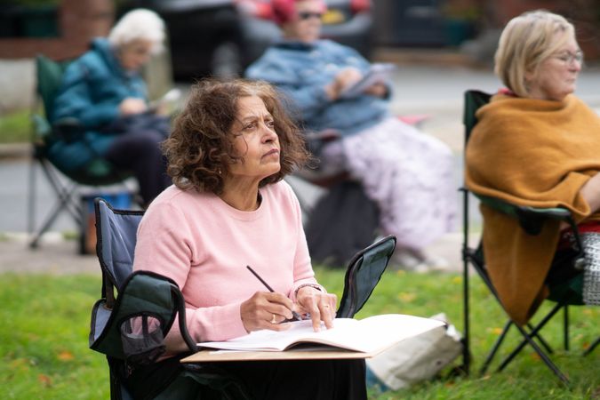 Indian woman focused on subject during drawing class