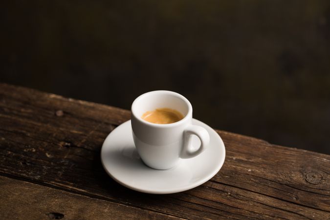 Cups of tasty hot coffee drink on wooden table