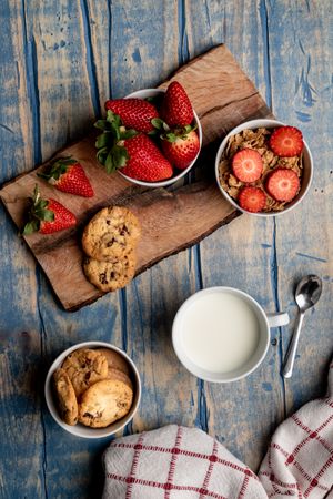 Glasses near fruits and cookies on table near napkin