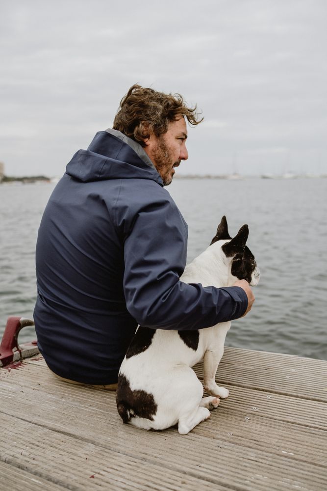 Man and dog resting on pier together