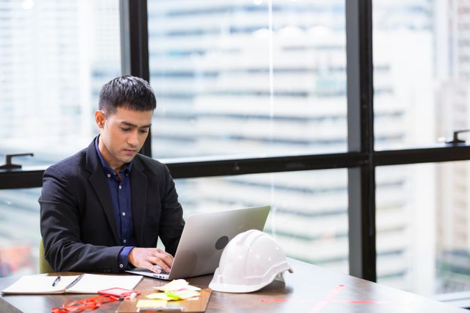 Thoughtful man on his work on laptop in office