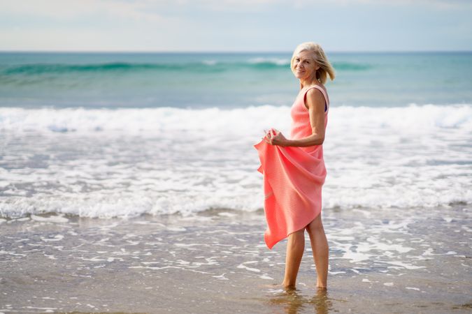 Older woman looking out to beautiful ocean