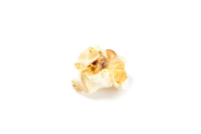 Piece of popcorn isolated on blank background, close up
