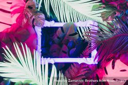 Creative fluorescent color layout made of tropical leaves with neon light square 5Qgogb