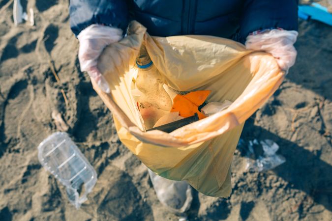 Girl showing garbage collected from the beach