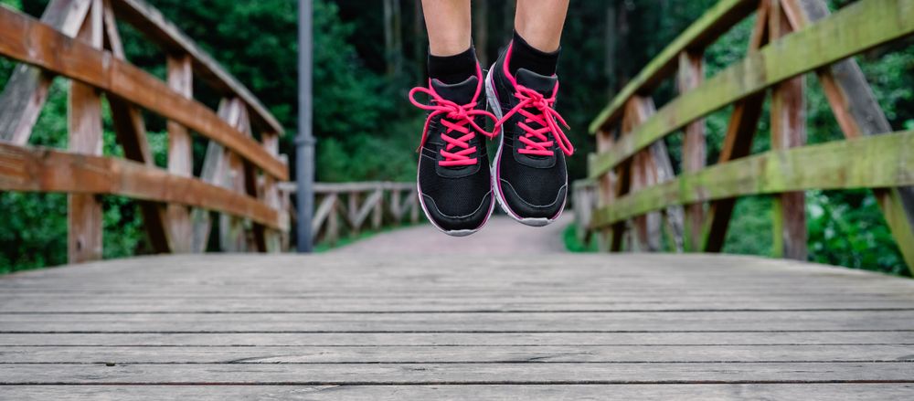 Athlete woman feet jumping outdoors