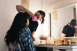 Bride being made up by a professional makeup artist