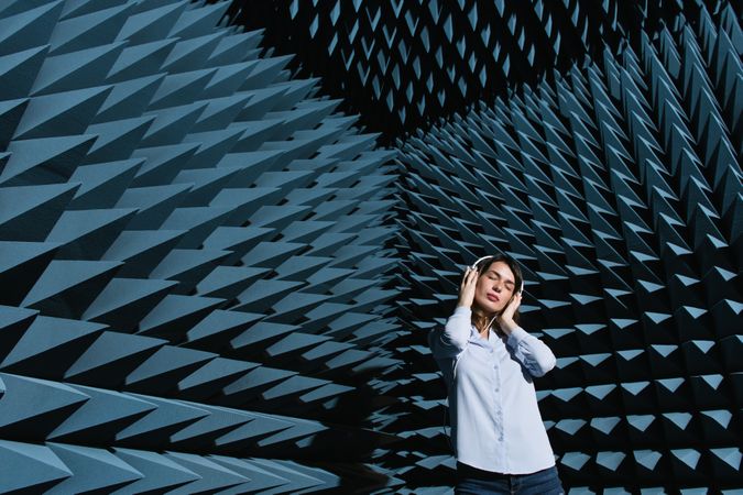 Woman in sound room listening to music