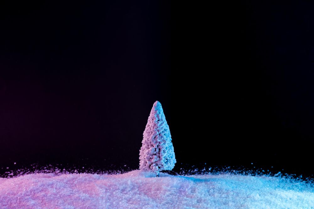 Snowy Christmas tree on snow in vibrant bold gradient holographic colors