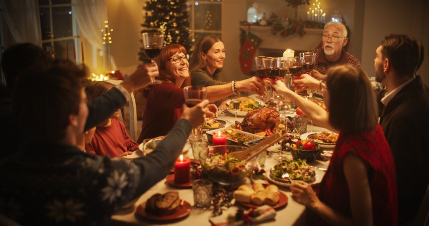 Parents, Children and Friends Spend Christmas Dinner Together at Home.