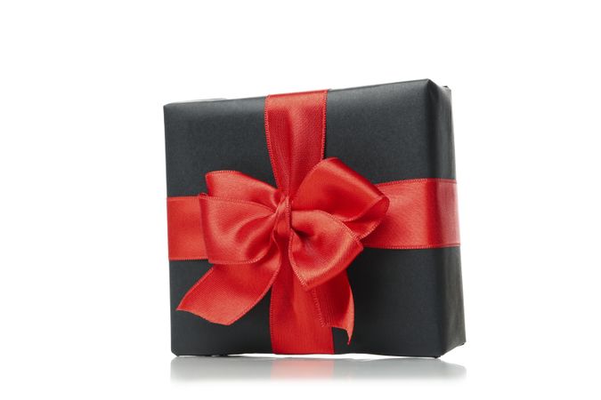 Gift box with red bow isolated on bright background