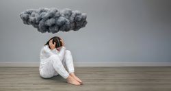 Unrecognizable woman under a dark storm cloud