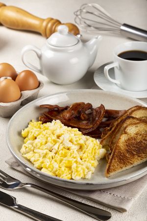 Breakfast with eggs, bacon and toast.