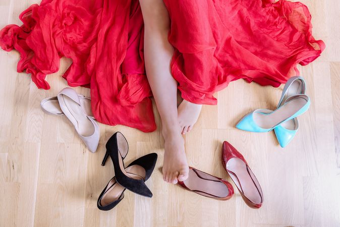 Empty woman feet surrounded by elegant shoes