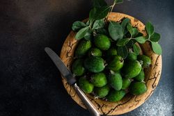Top view of organic fruit feijoa in rustic plate