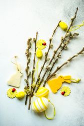 Easter card concept with yellow decorations on pussy willow branches