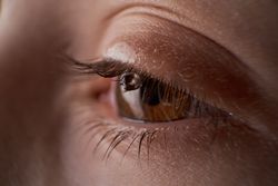 Eye of anonymous kid with tear