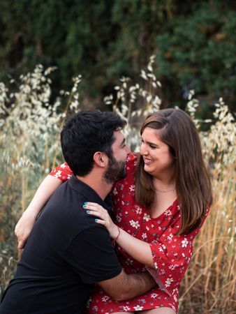 Young happy couple embracing in beautiful garden