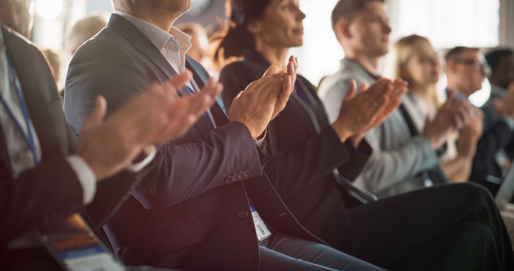 Close Up on Hands of Audience Applauding in Concert Hall During Business Forum Presentation. Technology Summit Auditorium Room With Corporate Delegates. Excited Entrepreneurs Clapping.