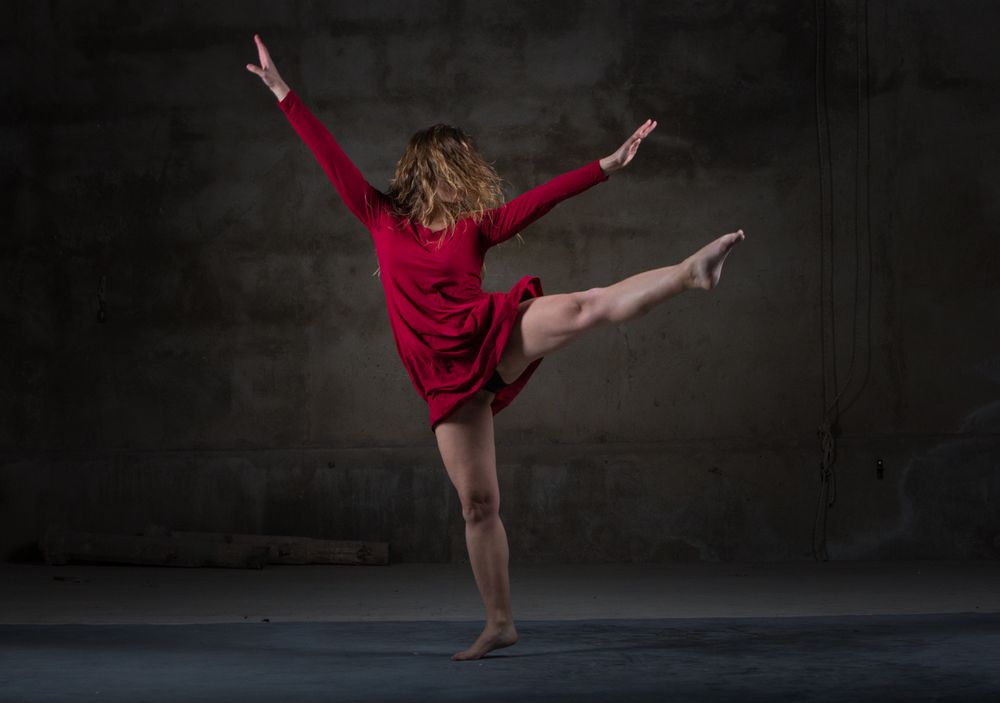 Young woman dancing in darkness