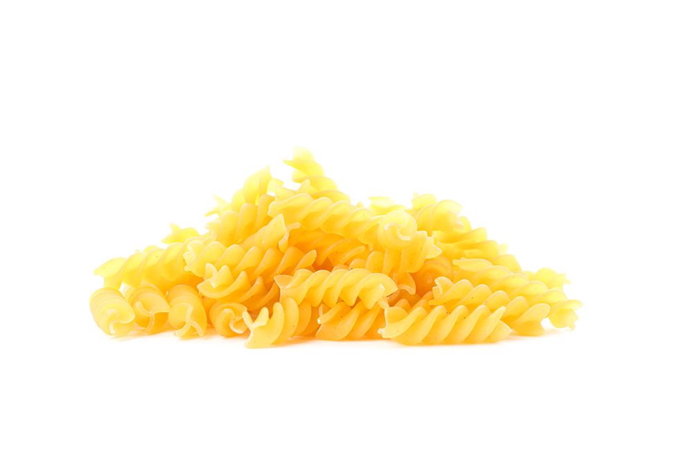Pasta isolated on light background, closeup. Dry uncooked whole pasta