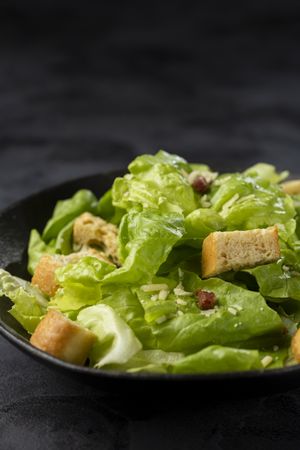 Caesar salad with croutons and bacon.