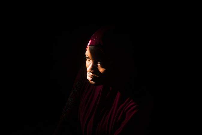 Portrait of African woman wearing hijab in a dark room