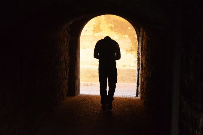 Silhouette of man standing at the doorway l