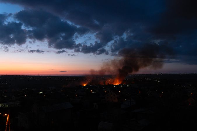 Large fire spreads rapidly in suburban neighborhood at sunset