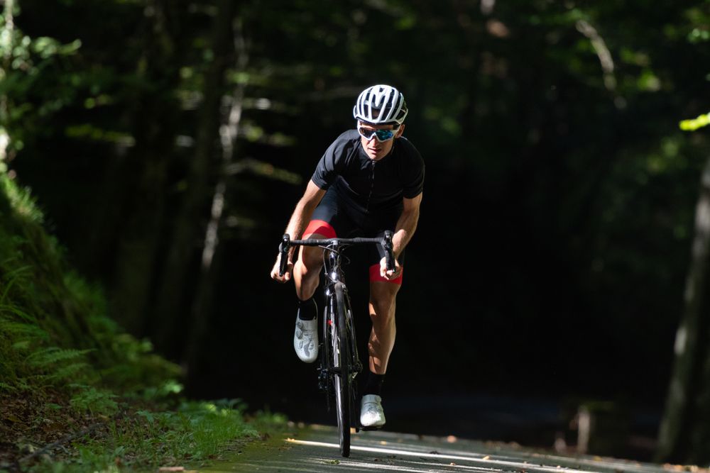 Professional cyclist riding bike in park