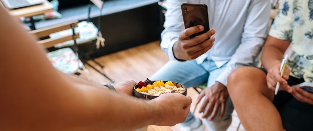 Chef showing healthy bowl to food bloggers and influencers taking photos in cooking master class