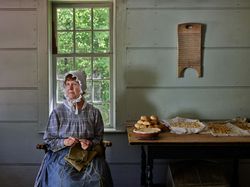 Costumed interpreter knitting at Old Sturbridge Village, Sturbridge, Massachusetts k4MJyb