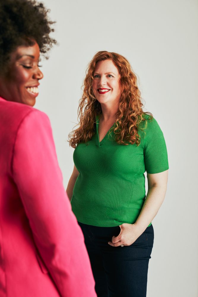 Two women in business casual clothing in studio