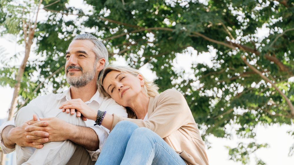 Relaxed couple sitting on grass together at park