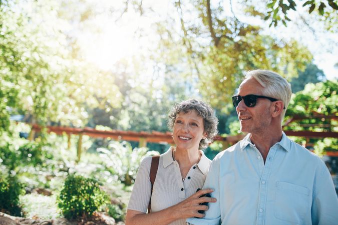Portrait of happy mature couple standing together in a park