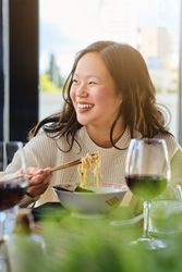 Woman eating ramen in cafe