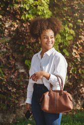 Young Black businesswoman in stylish outfit in park