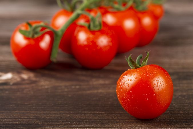 Ripe tomatoes on the wooden table.