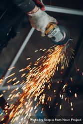 Cropped image of a hand welding a frame 489gYb