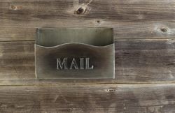 Empty old metal mailbox on weathered wood