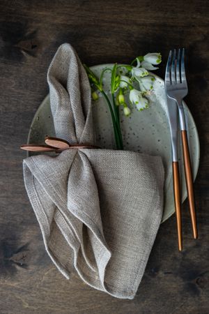 Top view of table setting for Easter dinner with delicate flowers