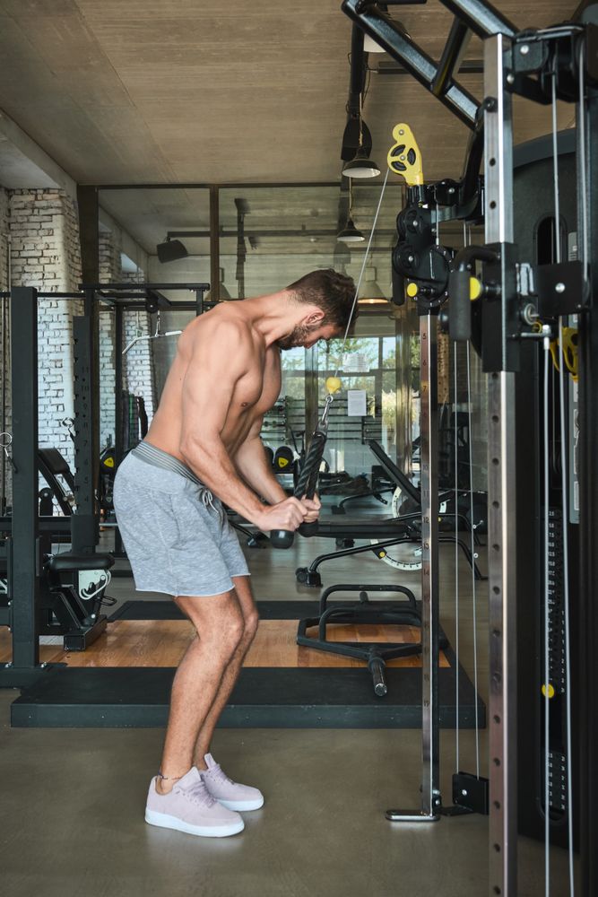 Guy using exercise machine in gym