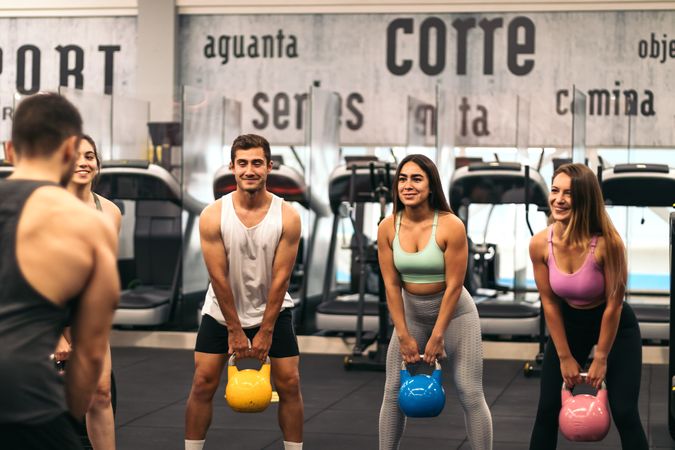 fitness class lifting kettlebells in a gym