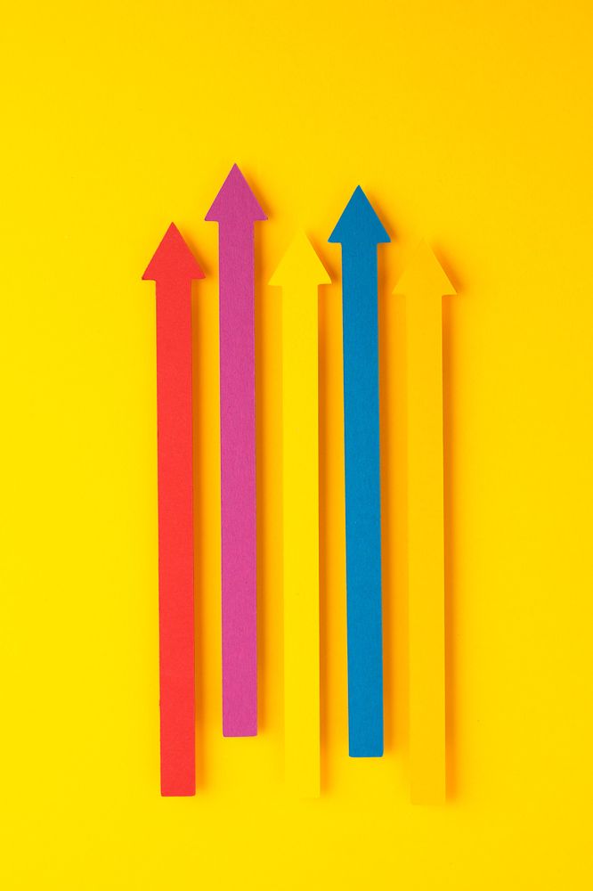 Colorful paper arrows pointing in the same direction